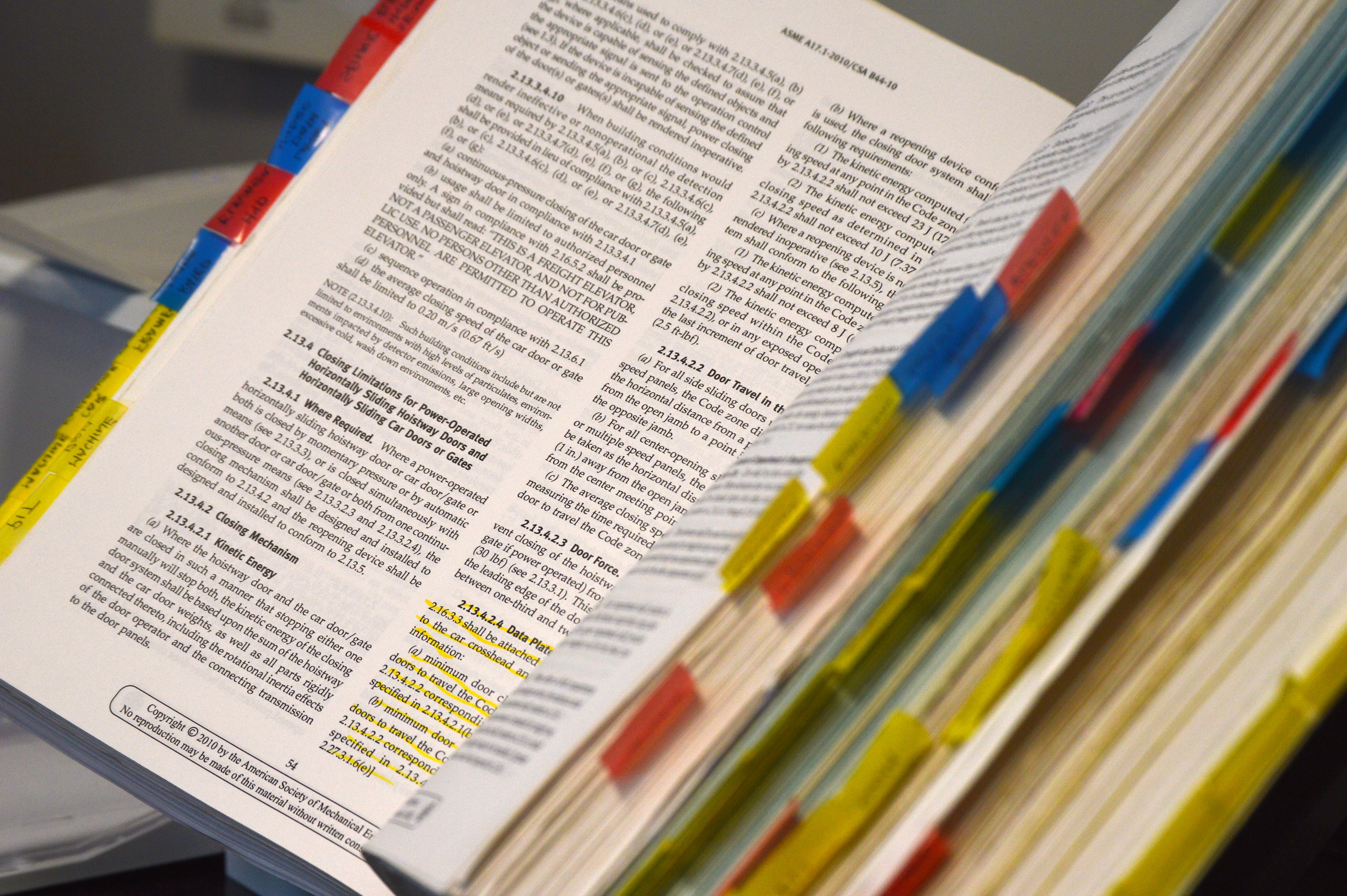 A stock photo of an open book with many tabs on either side.