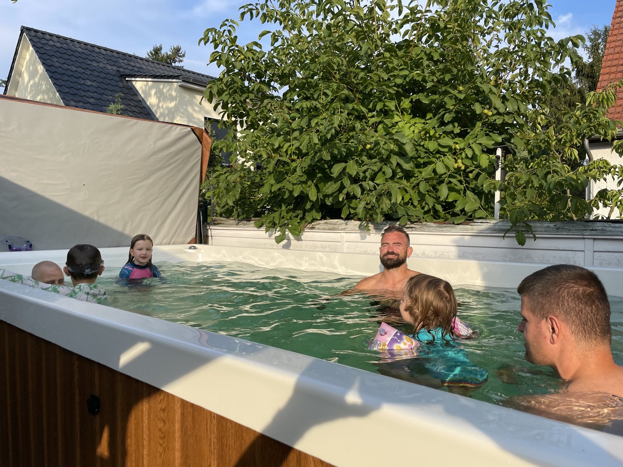 A few members of the team enjoying the pool in Tim's garden.